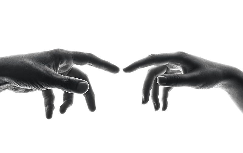 Two outstretched hands with forefingers almost touching